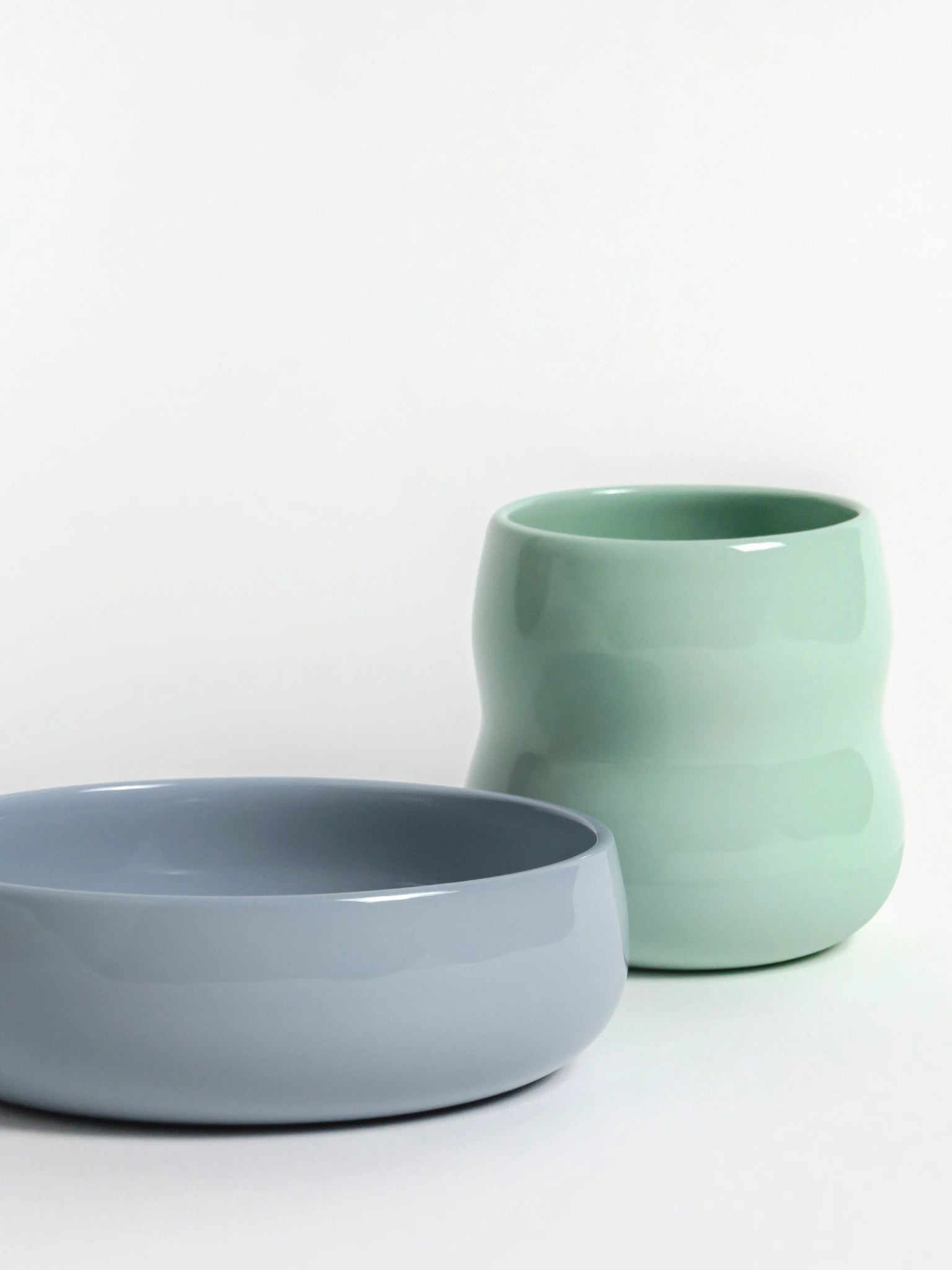 Kindergeschirr aus Porzellan, Frontansicht des Kinderbechers in Agave und der Kinderschale in der Farbe Kornblume.